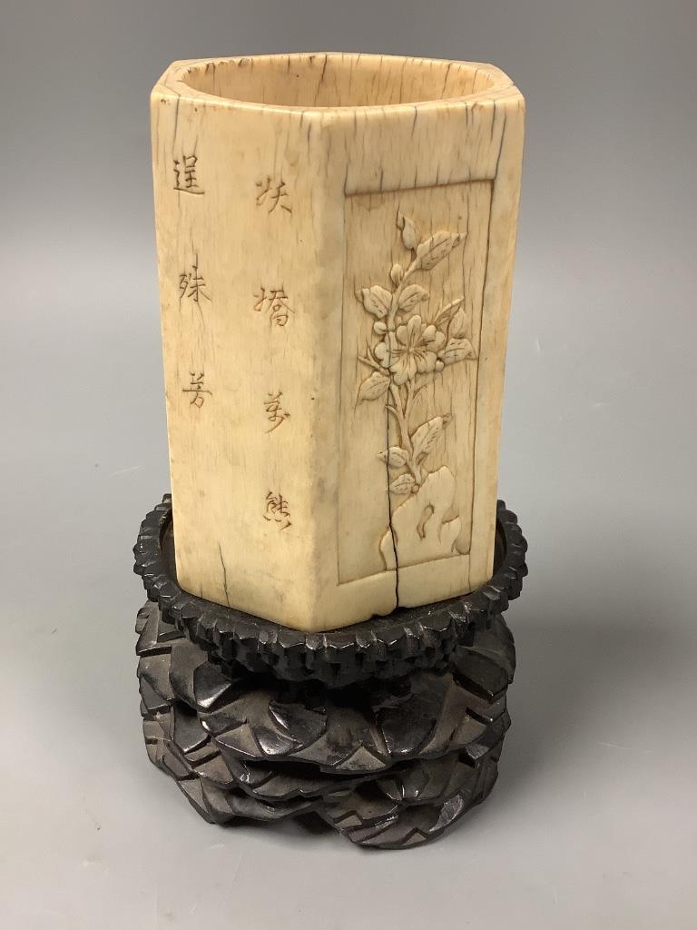 A Chinese inscribed ivory hexagonal brushpot, 17th/18th century, 12.2cm high, replacement wood base panel, age cracks, with associated hardwood stand